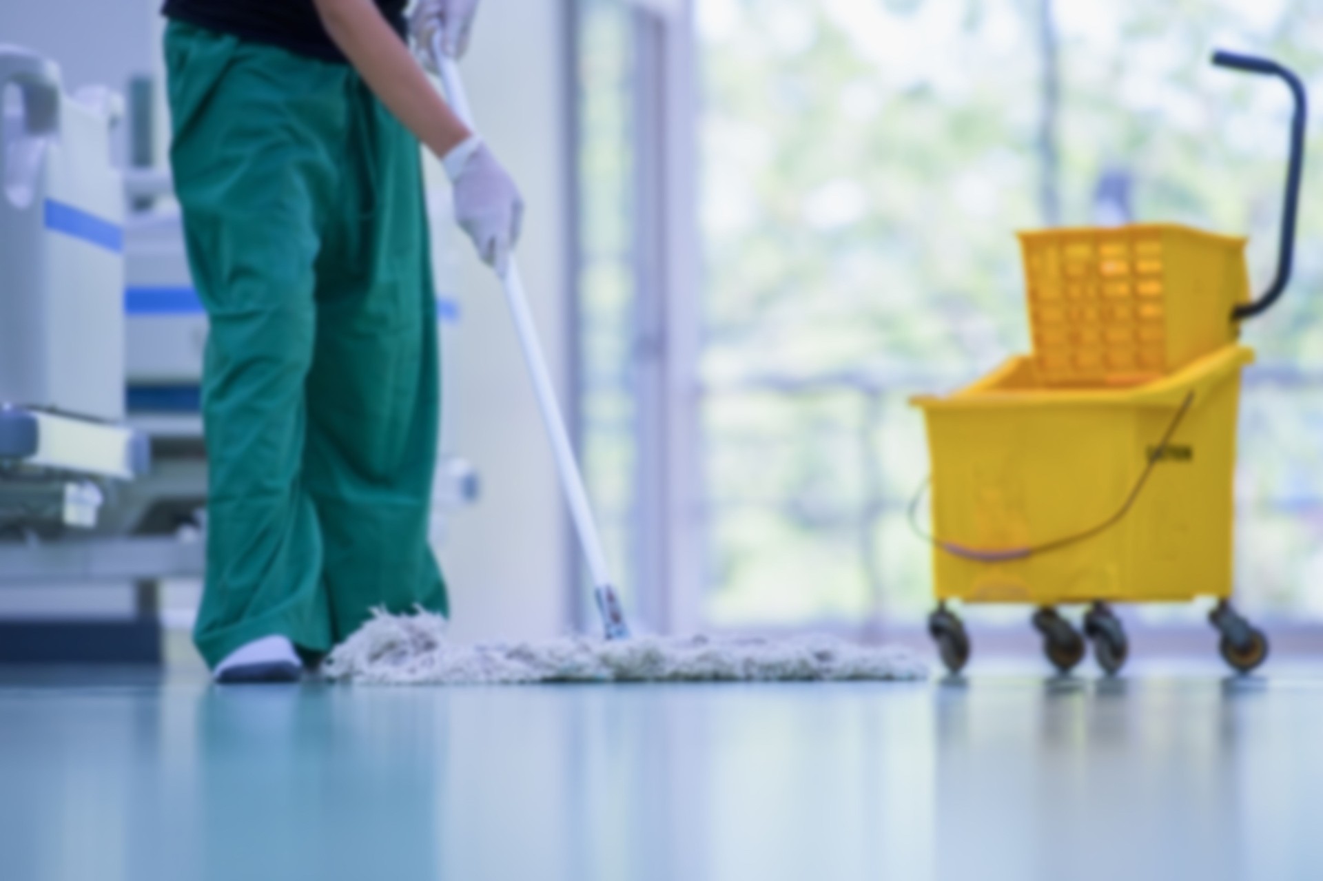 Floor care and cleaning services with washing mop in sterile factory or clean hospital.